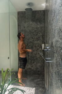 A person in a walk-in shower.