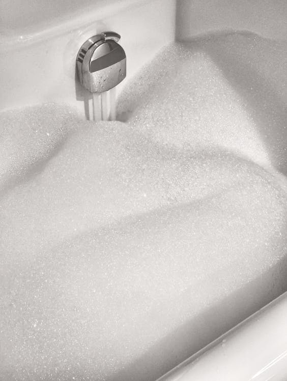 close up of bubbles in the water in a bathtub