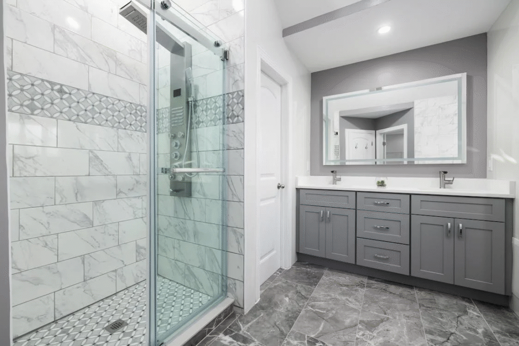 modern bathroom with grey interior with a shower and storage space