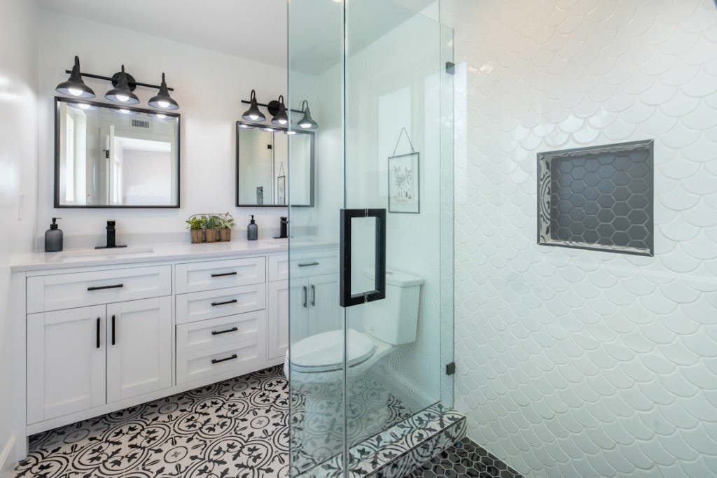 modern bathroom with two sinks with plenty for storage space and a glass door