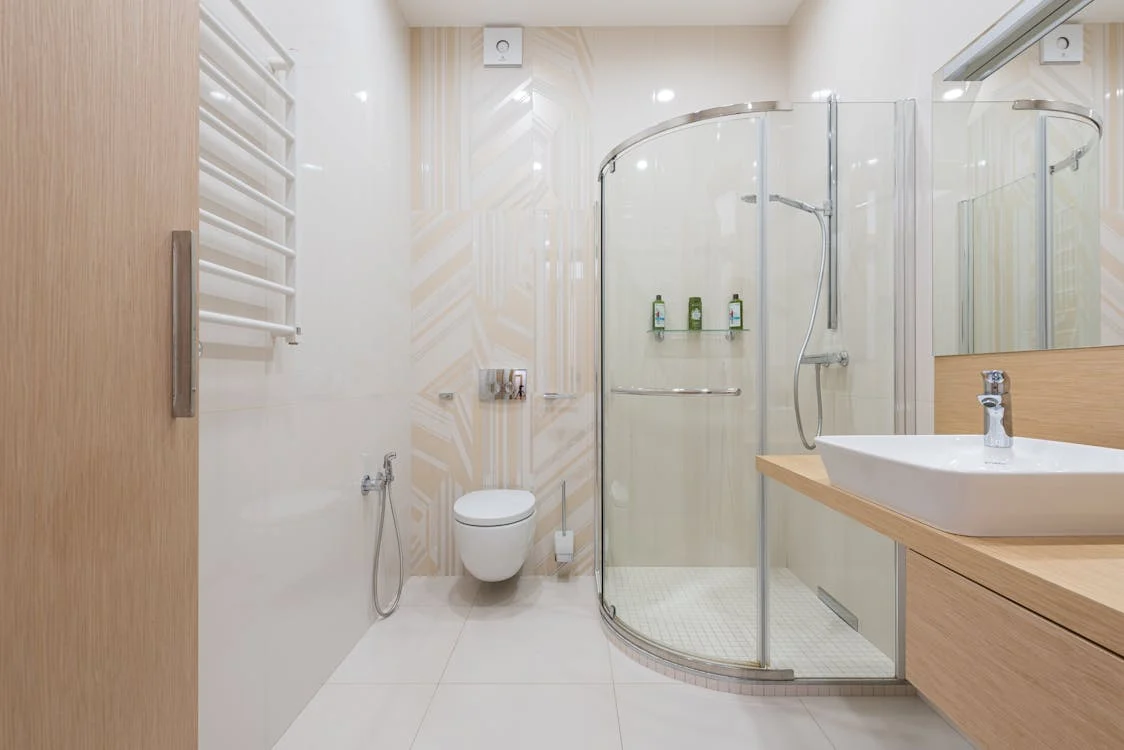 white washroom interior with a spacious glass walk in shower