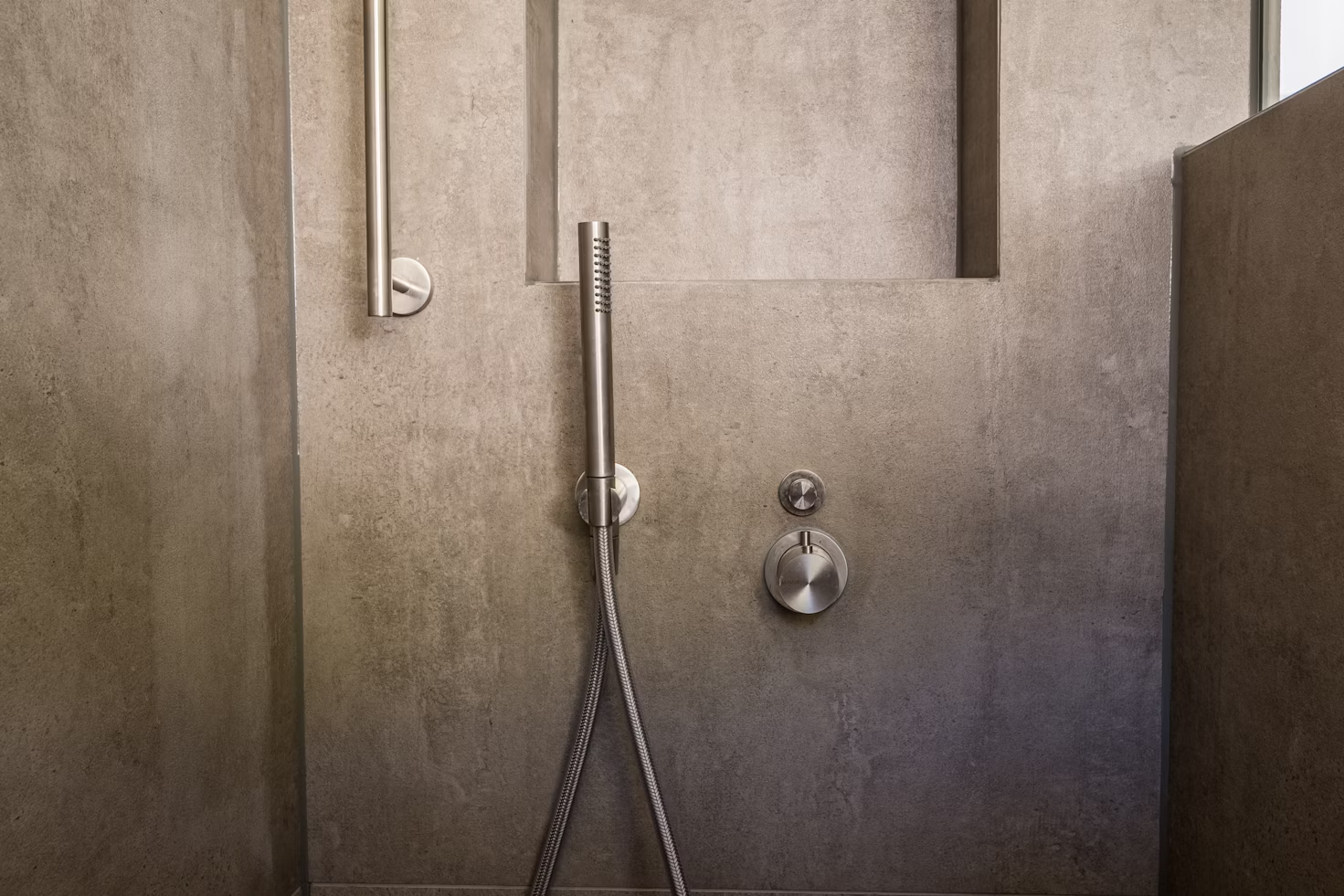  inside a walk in shower with glass and built-in shower attached to the wall