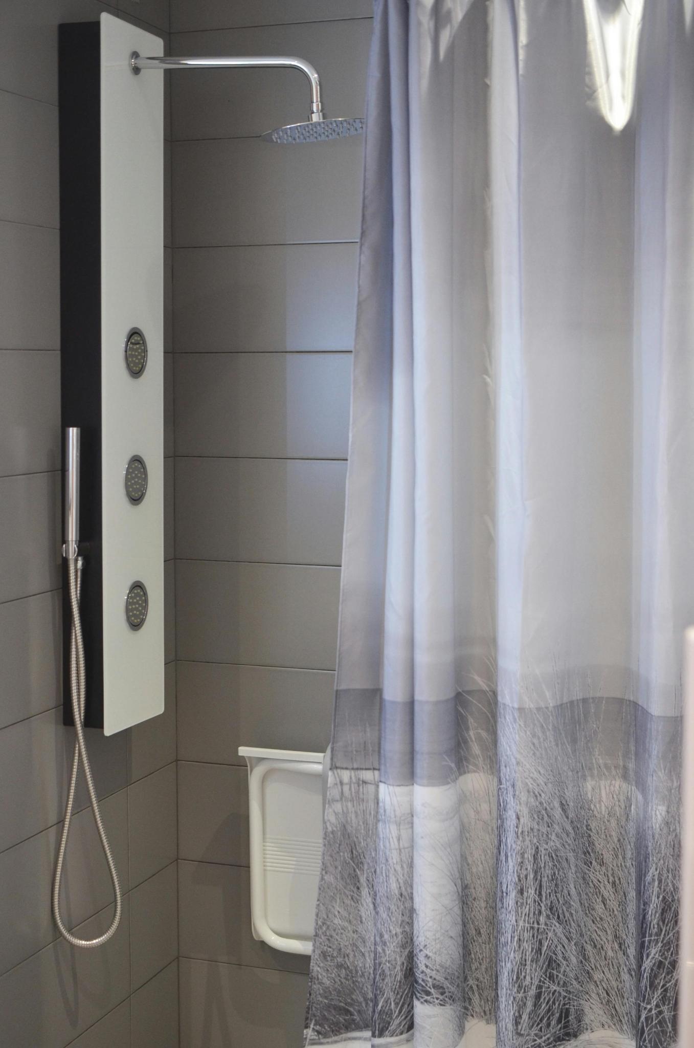 modern shower with grey walls and a shower curtain