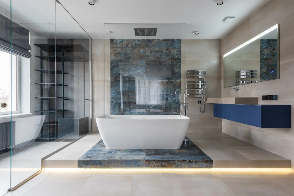 Modern bathroom interior featuring a freestanding tub, large tiles, and sleek fixtures
