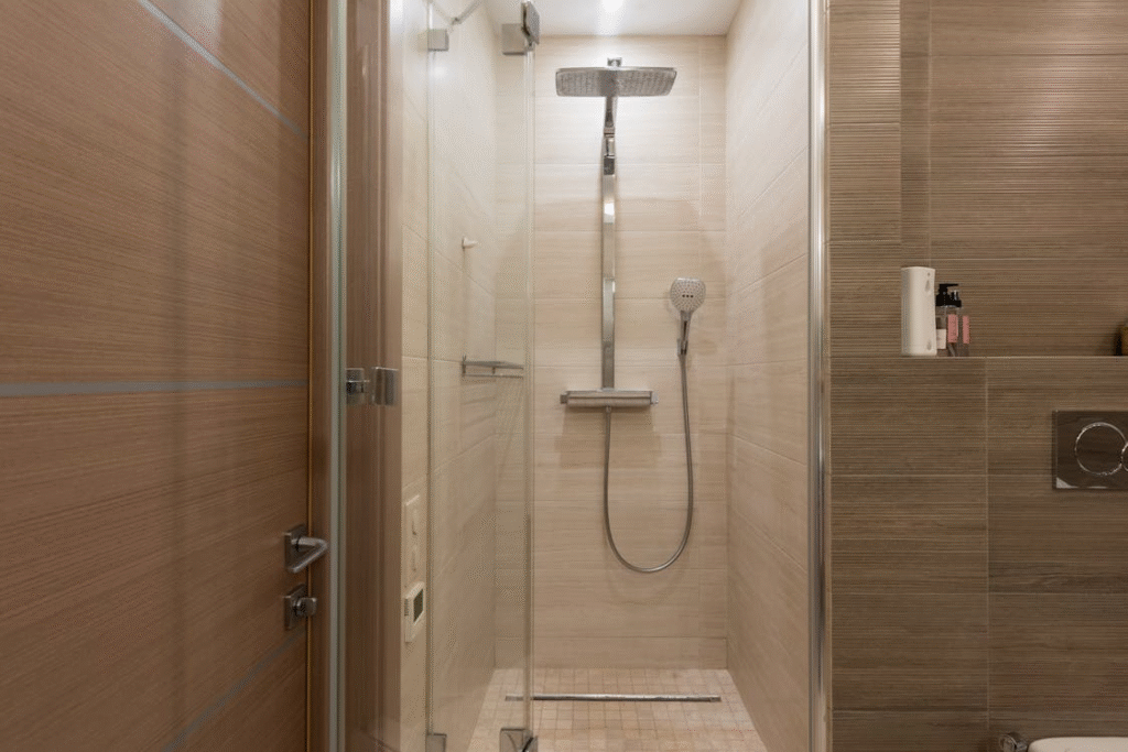 A modern shower cubicle in neutral beige tones.