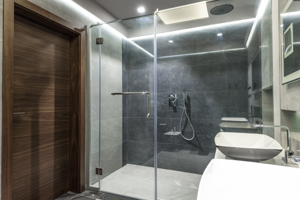 Modern wet room bathroom with open-concept shower, minimalist fixtures, and floor-level drainage
