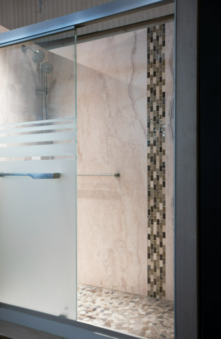 A modern bathroom with glass and a shower handle