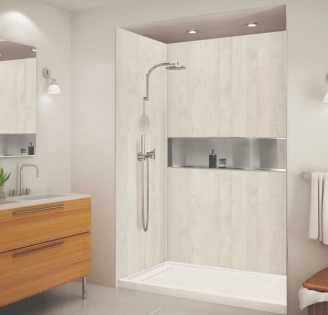 Newly renovated shower with light tile walls, niche shelving, and rainfall showerhead