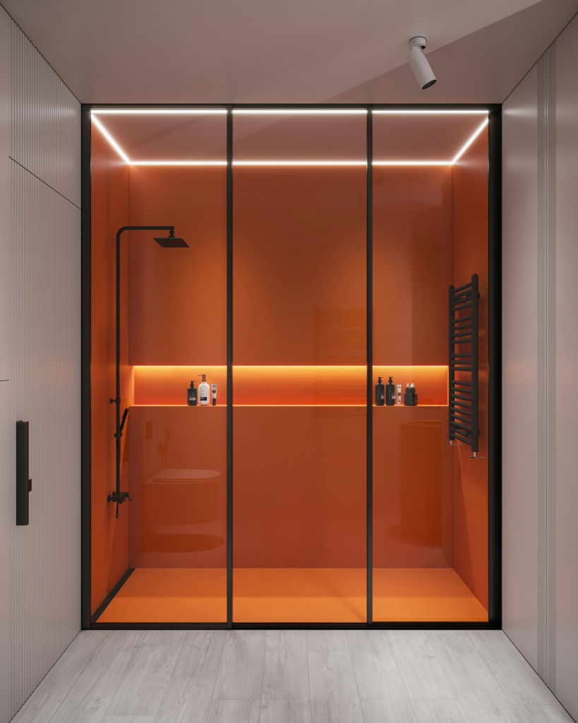 Frameless glass walk-in shower with amber panels, recessed shelf lighting, and matte black fixtures